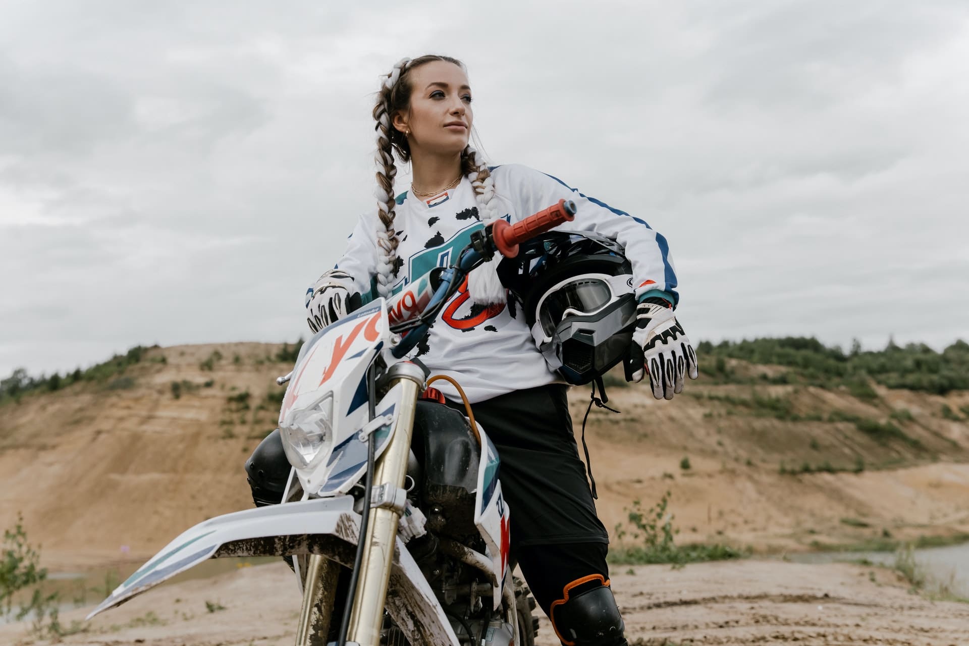 Woman On Dirt Bike Holding Helmet